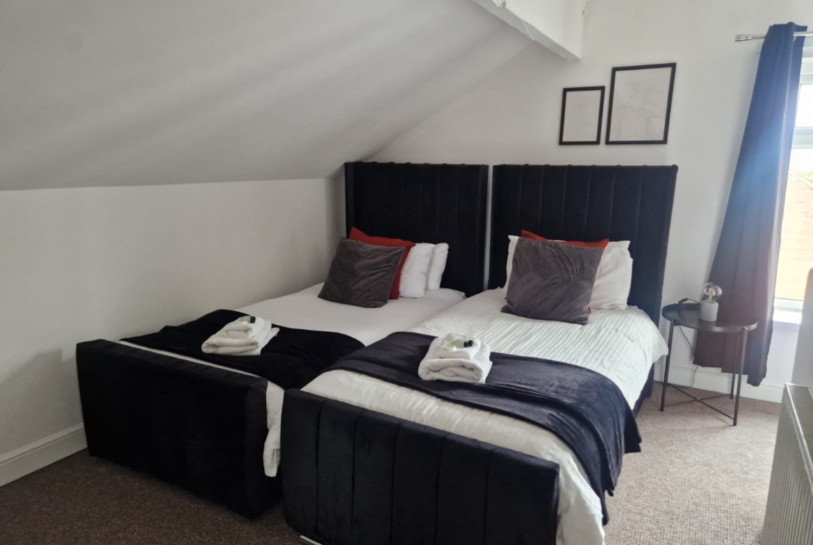 Two single-beds with white sleek sheets for contractor accommodation by hmh stays