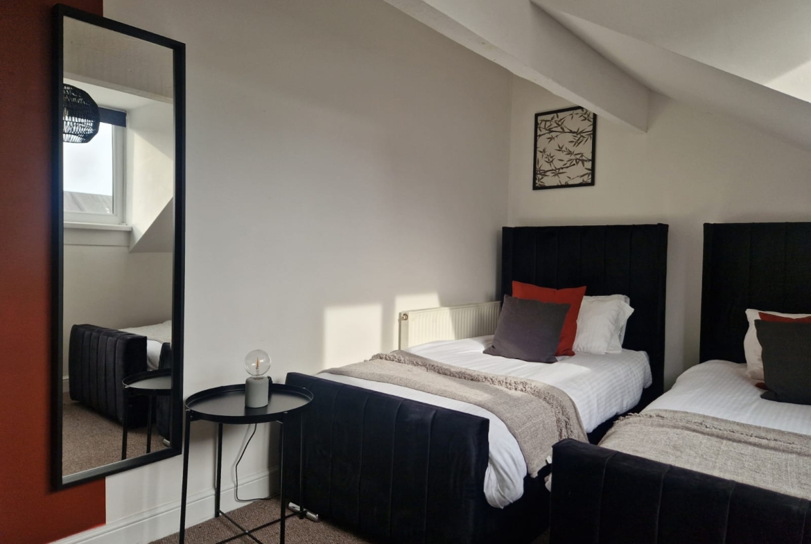 Two single beds listed by hmh stays in UK