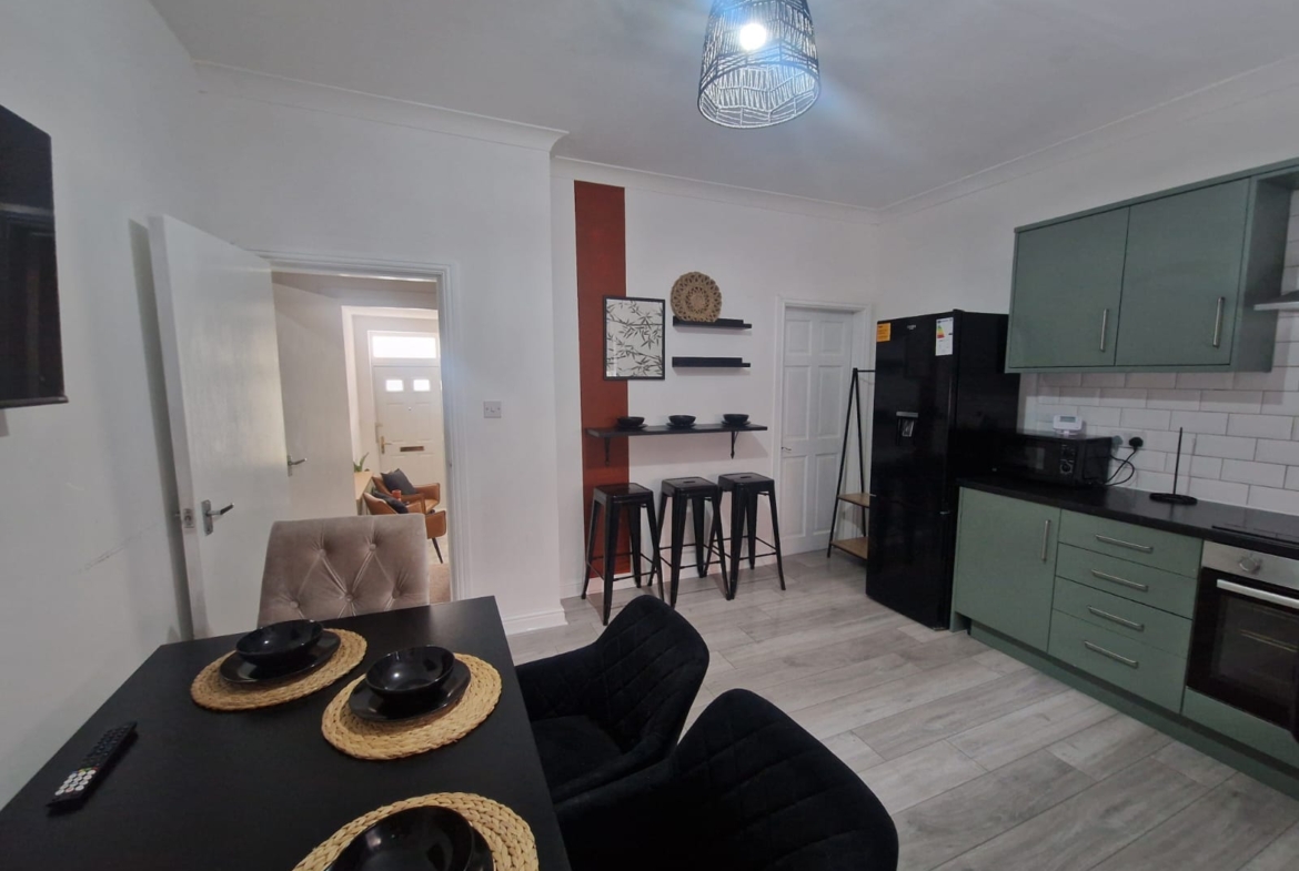Dining table with the fully equipped kitchen by hmh stays