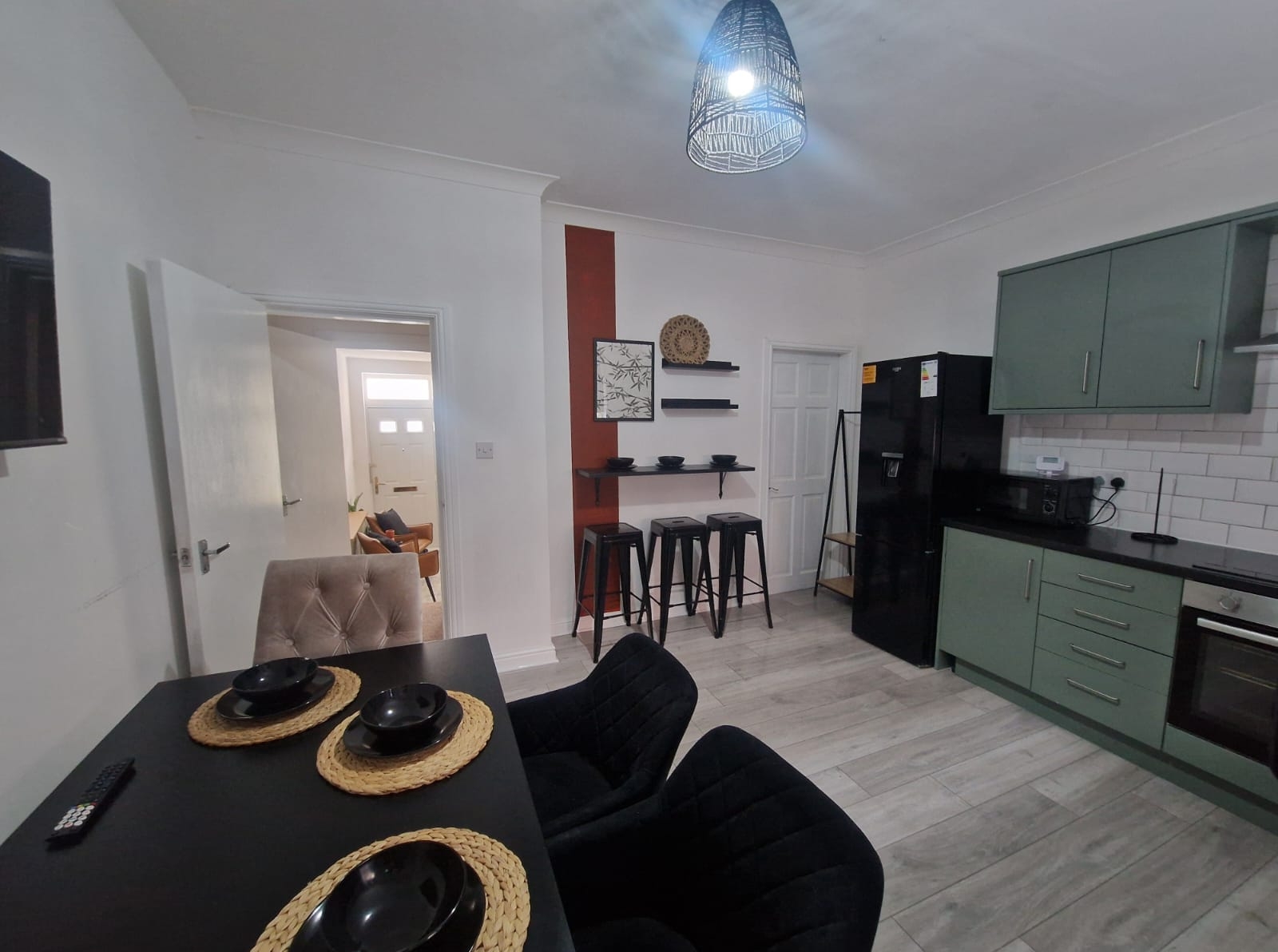 Dining table with the fully equipped kitchen by hmh stays