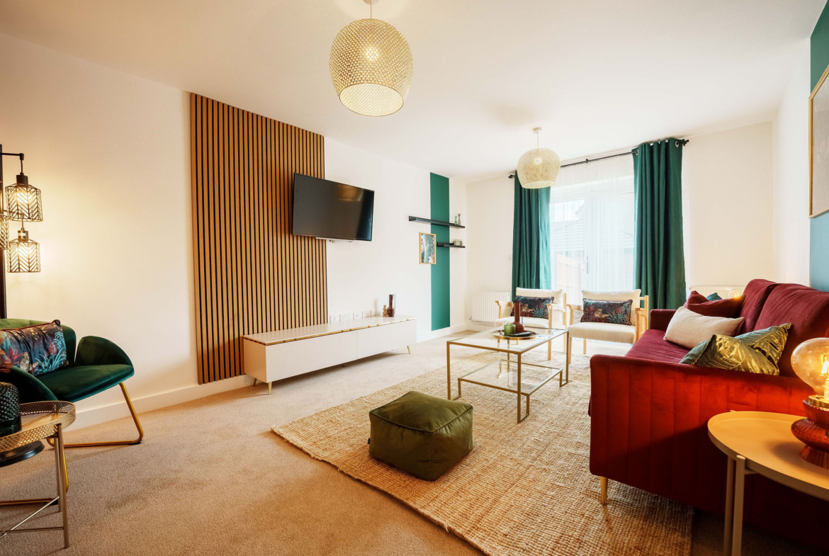 TV lounge with Red sofa set listed in the property of HMH Stays providing long-term accommodation