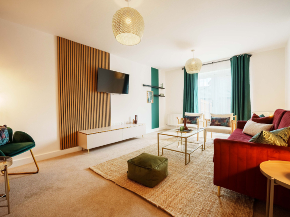 TV lounge with Red sofa set listed in the property of HMH Stays providing long-term accommodation