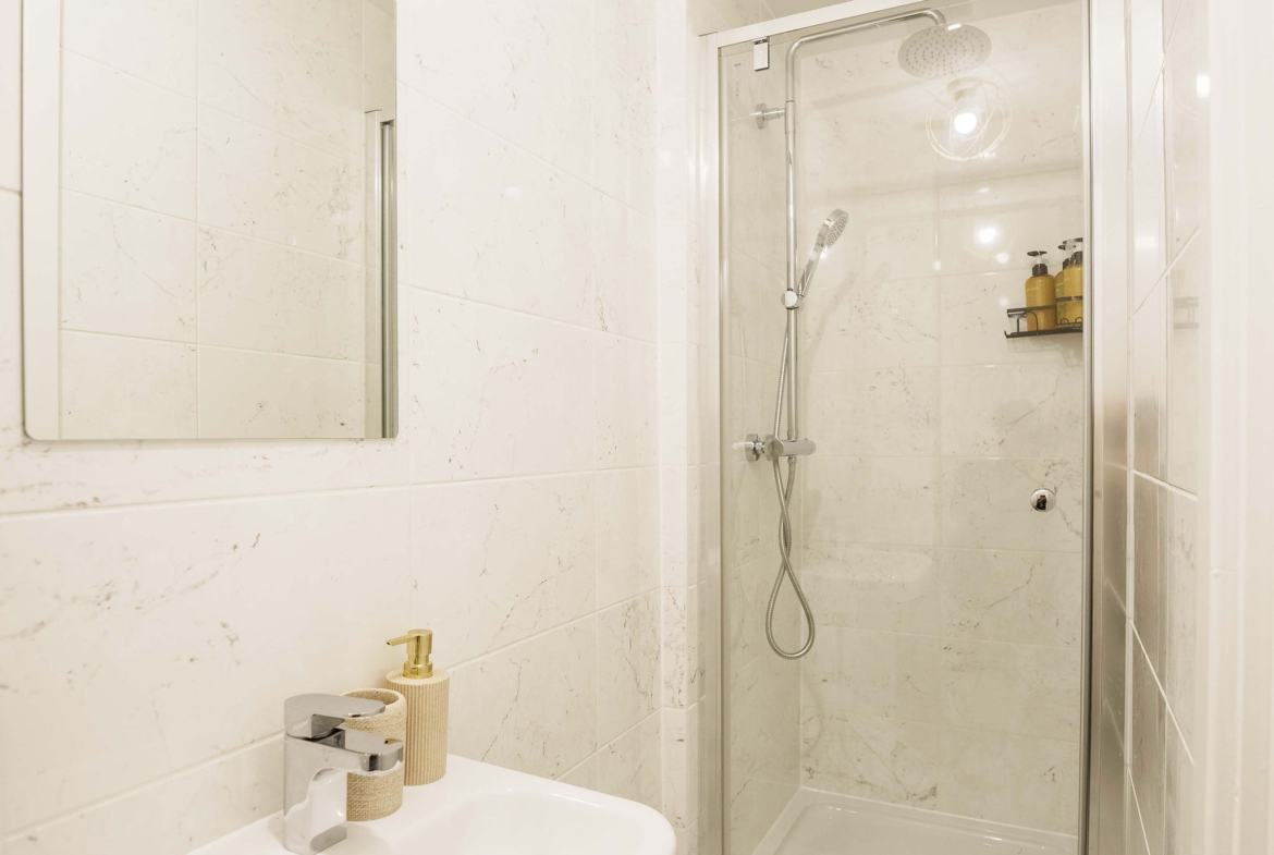 Shower facility along wash basin in the property of HMH Stays