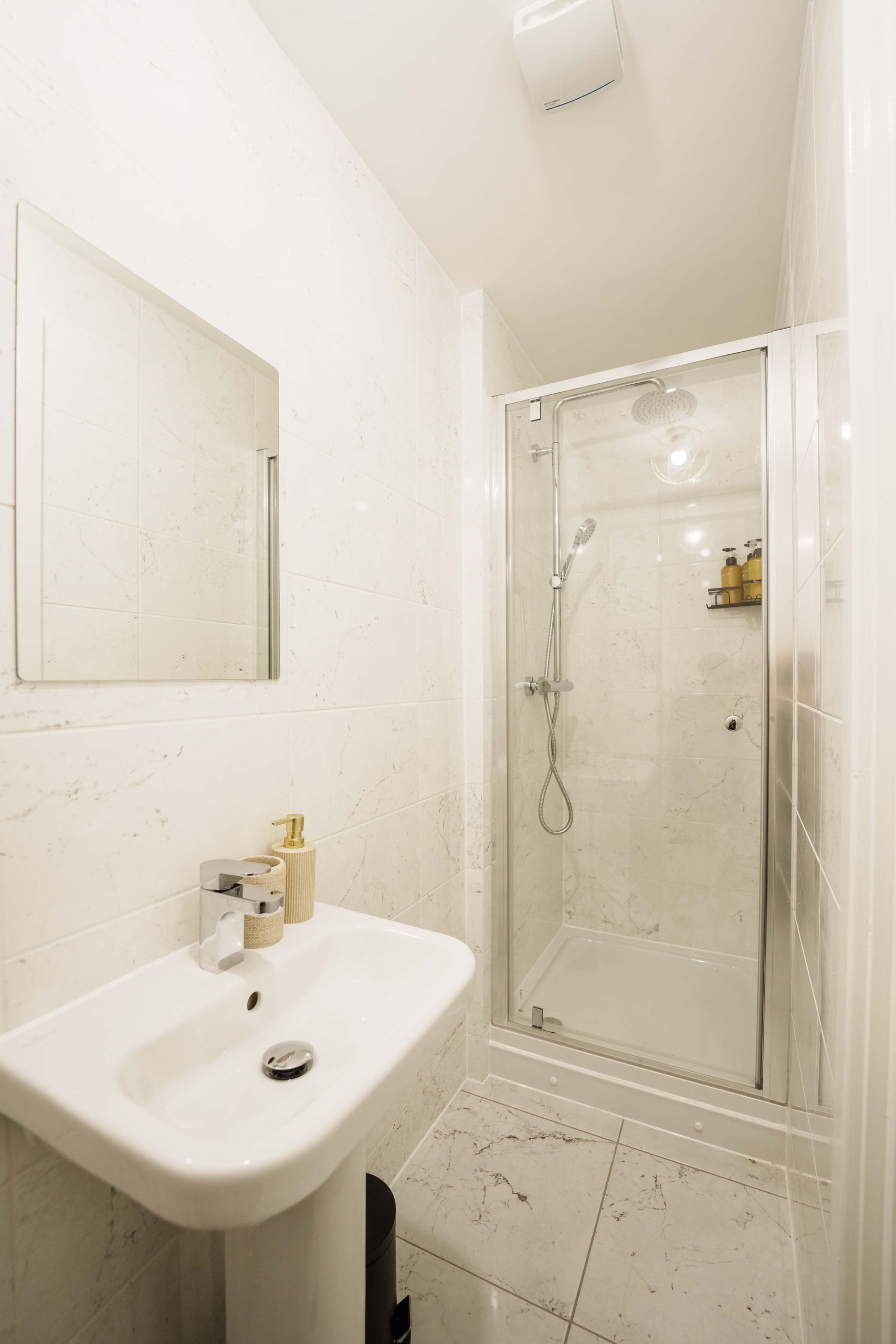 Shower facility along wash basin in the property of HMH Stays
