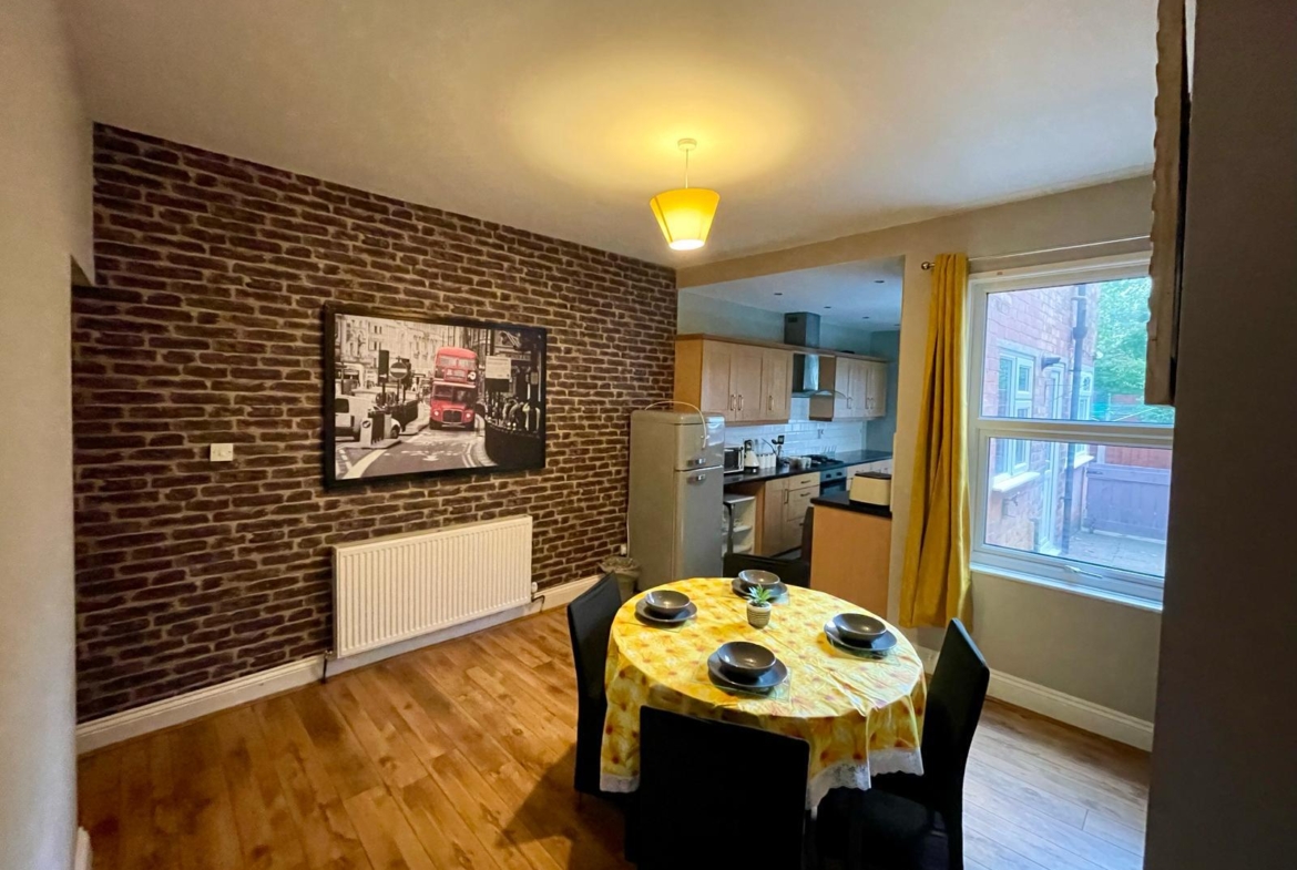 Dining table with the lcd and kitchen in the accommodation of hmh stays providing long-term contractor accommodation