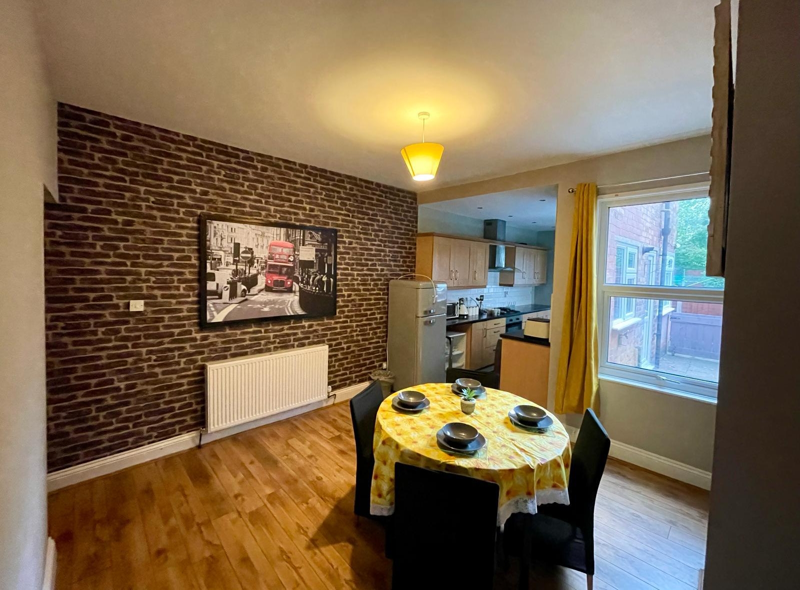 WhatsApp Image 2025-12-21 at 10.16.15 B Dining table with the lcd and kitchen in the accommodation of hmh stays providing long-term contractor accommodation