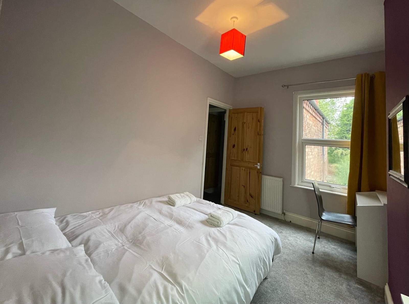 WhatsApp Image 2025-12-21 at F Double bed with the white sheet in the property of hmh stays