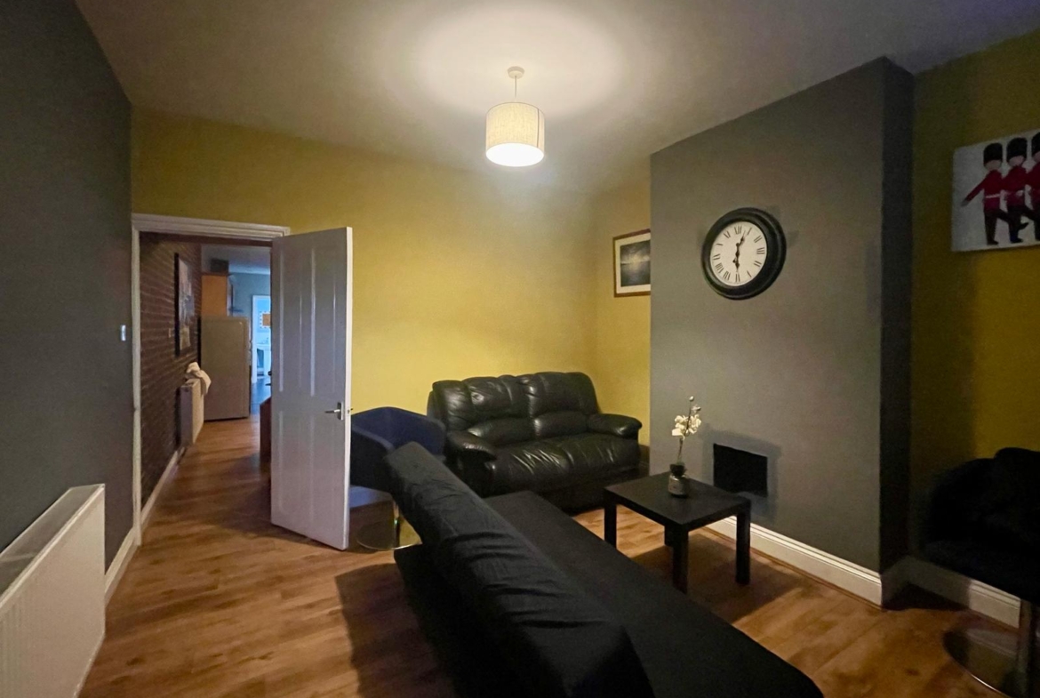 Sofa set and the wall watch hanging in the property of hmh stays