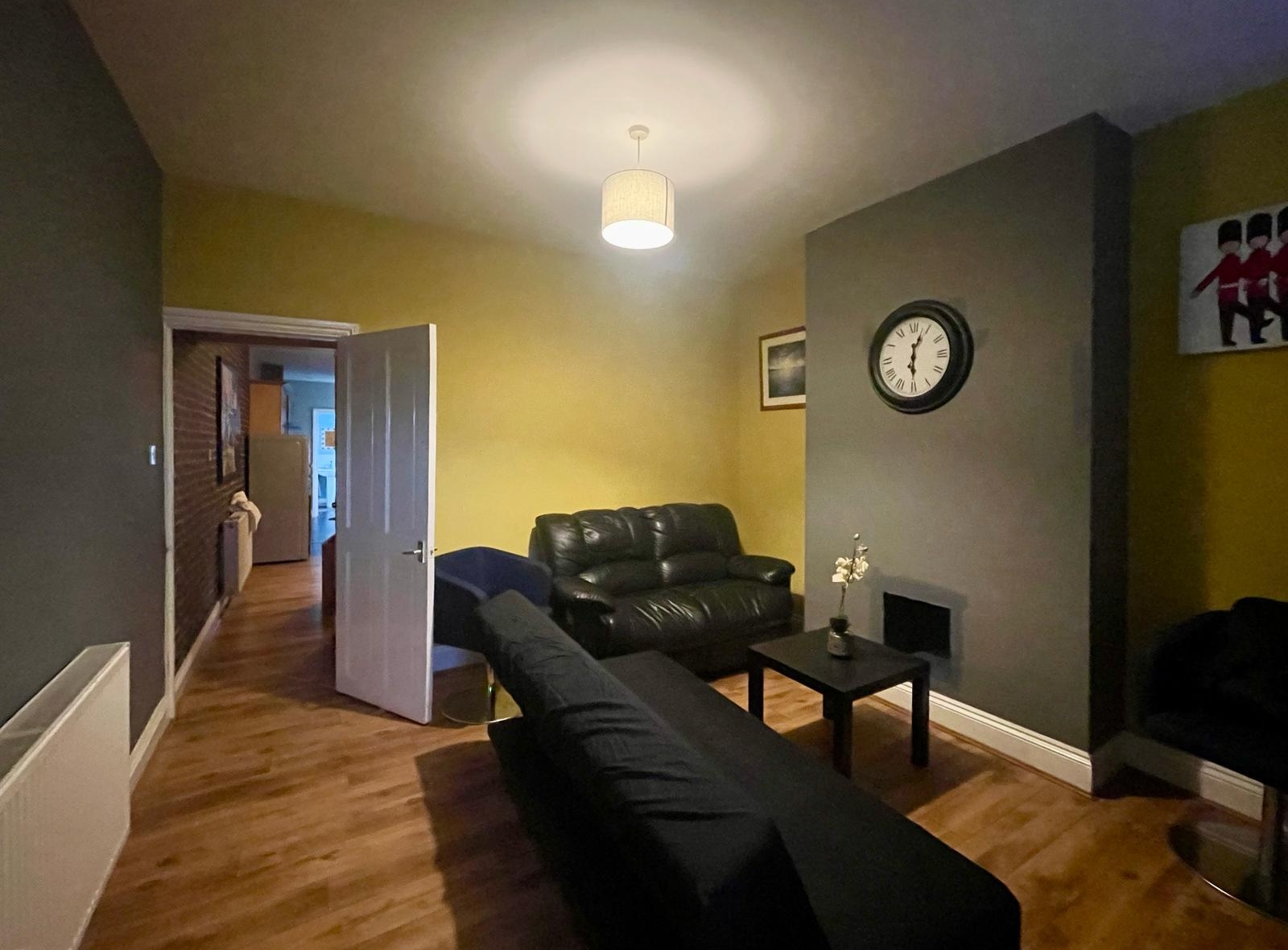 WhatsApp Image 2025-12-21 at V Sofa set and the wall watch hanging in the property of hmh stays